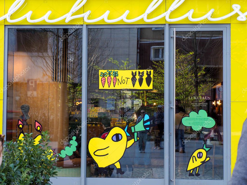 Cheerful Yellow Storefront with Playful Duck Logo and Bright Interior Creating Inviting Atmosphere