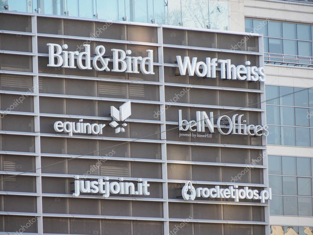Modern Office Building Exterior with Multiple Law Firm Logos Including Bird & Bird and Wolf Theiss