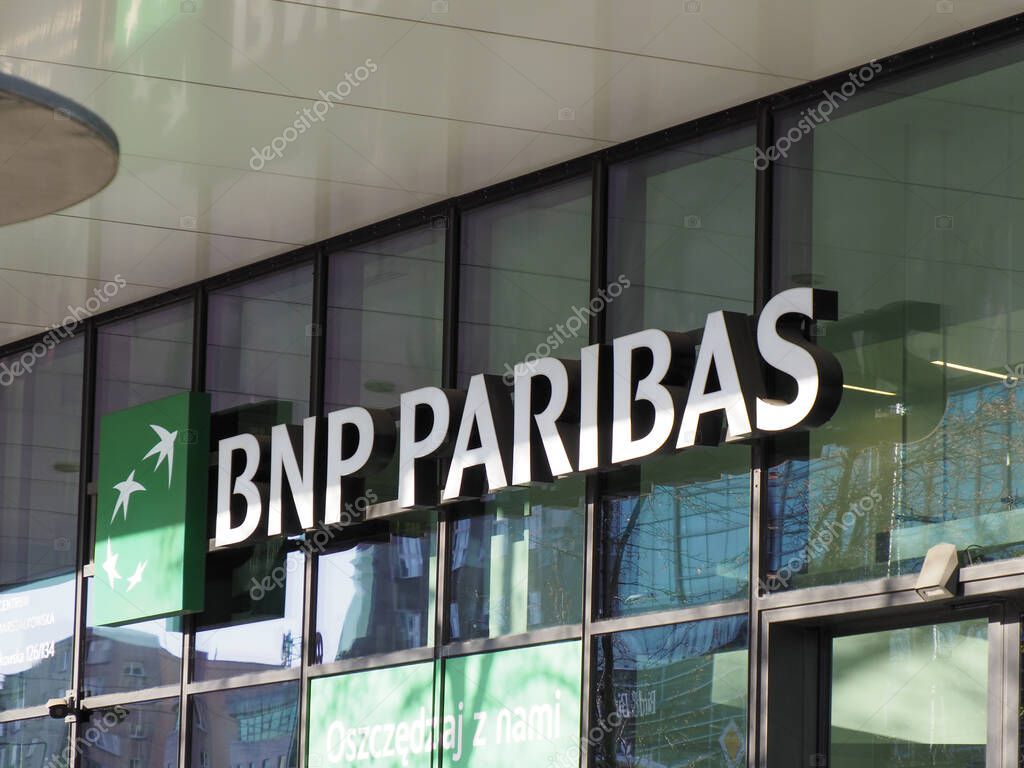 BNP Paribas Modern Banking Sign Illuminated on Glass Office Building Facade at Dusk