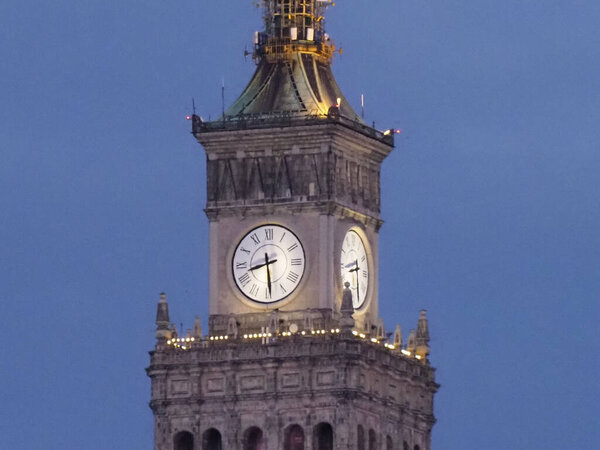 Ornate Palace of Culture Clock Tower Illuminated at Night Against Blue Sky