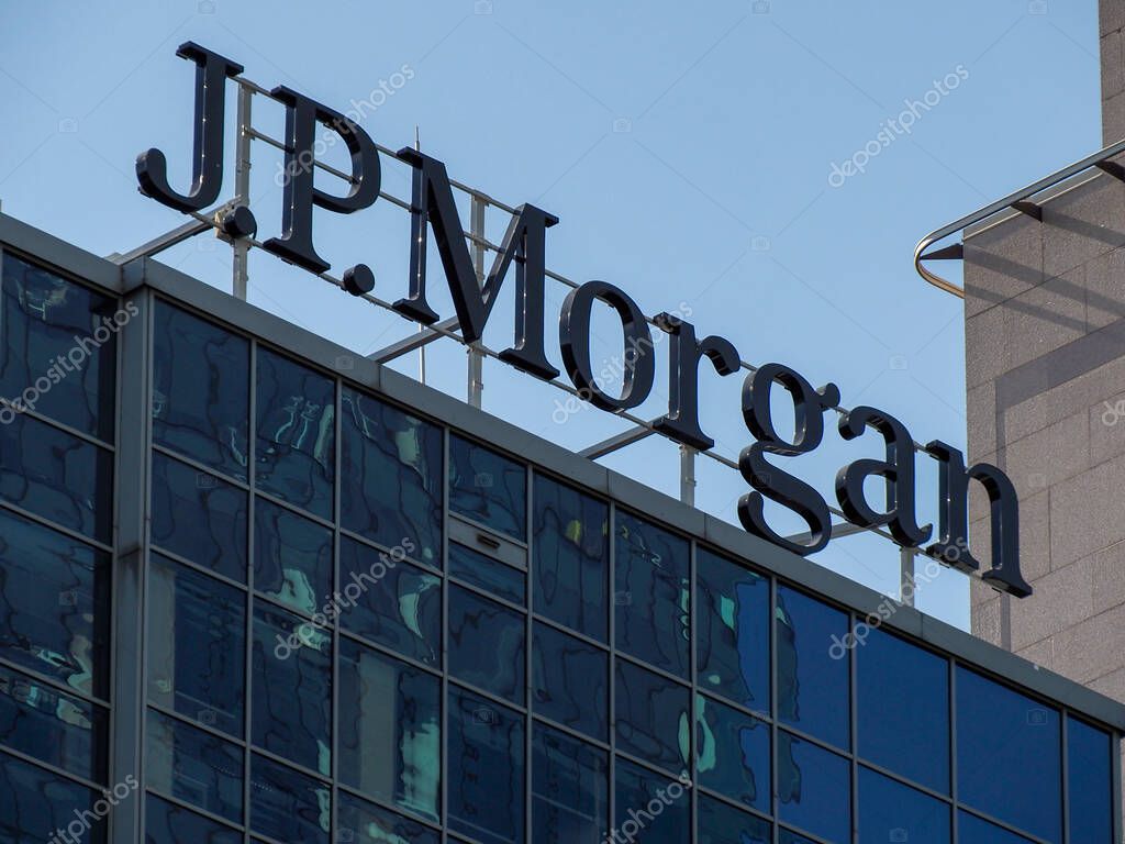 JP Morgan Corporate Headquarters Logo Displayed on Modern Glass Office Building Against Clear Blue Sky