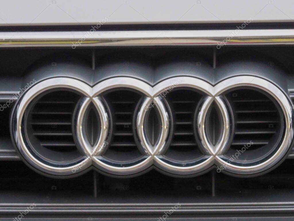 Gleaming Audi Four Ring Logo Mounted on Silver Grille Showing Premium Vehicle Branding