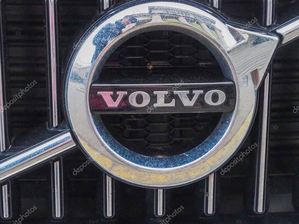 Shiny Chrome Volvo Emblem on Dark Grille Showcasing Luxury Automotive Brand Detail
