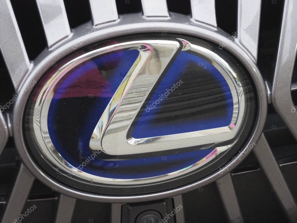 Polished Lexus L Emblem with Blue Accents on Black Grille Representing Japanese Luxury