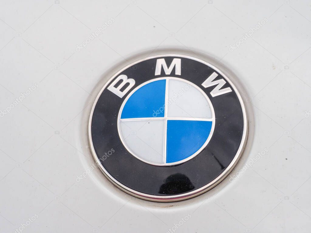 Closeup of BMW car logo emblem on vehicle showing iconic blue and white circular design