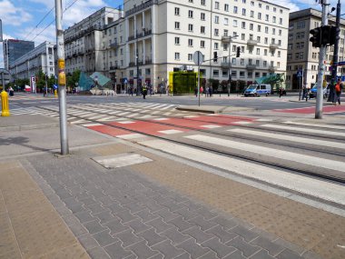 Wide urban street with tram tracks and modern architecture showcasing contemporary city infrastructure design