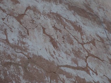 Yıpranmış taş duvar dokusu doğal yaşlanma ve aşınma etkilerini gösteriyor.