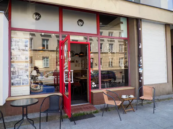 Kırmızı tenteli ve açık hava oturma alanı olan küçük bir mahalle kafesi rahat bir sokak yemeği atmosferi yaratıyor.