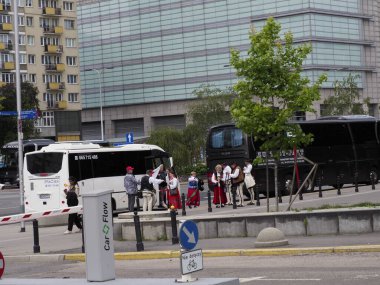 Yolcu ve şehir mimarisi geçmişi olan modern şehir istasyonunda beyaz toplu taşıma otobüsü