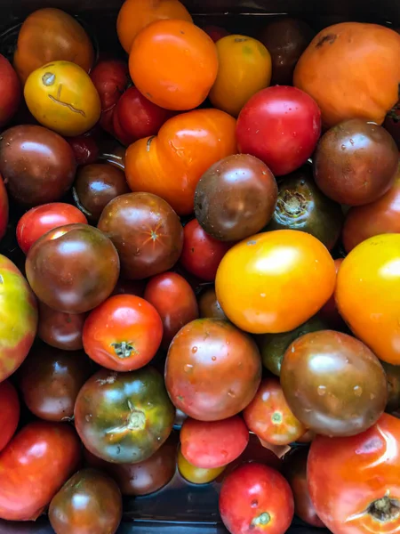 Colorful tomatoes of different sizes and kinds, top view. High quality photo