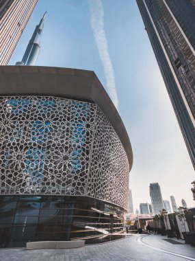 Dubai Opera house in Downtown Dubai, surrounded by skyscrapers and Burj Khalifa, in UAE, United Arab Emirates. High quality photo