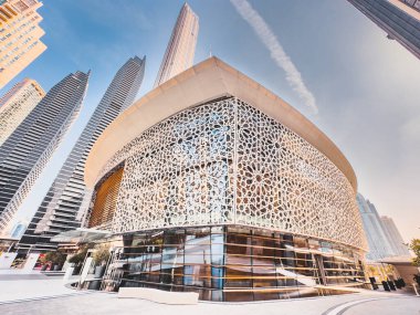 Dubai Opera house in Downtown Dubai, surrounded by skyscrapers and Burj Khalifa, in UAE, United Arab Emirates. High quality photo