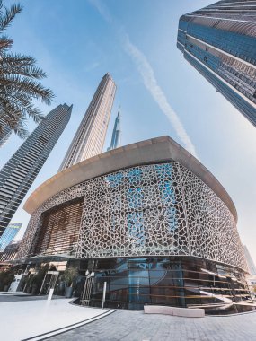 Dubai Opera house in Downtown Dubai, surrounded by skyscrapers and Burj Khalifa, in UAE, United Arab Emirates. High quality photo