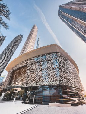 Dubai Opera house in Downtown Dubai, surrounded by skyscrapers and Burj Khalifa, in UAE, United Arab Emirates. High quality photo
