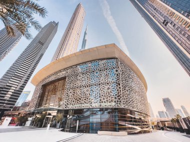 Dubai Opera house in Downtown Dubai, surrounded by skyscrapers and Burj Khalifa, in UAE, United Arab Emirates. High quality photo