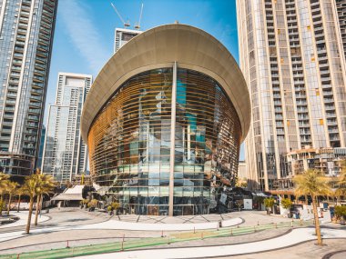 Dubai Opera house in Downtown Dubai, surrounded by skyscrapers and Burj Khalifa, in UAE, United Arab Emirates. High quality photo