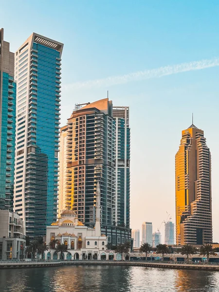 stock image Dubai Marina Mosque, harbour, cruise boat and canal promenade view at sunset, in Dubai, United Arab Emirates. High quality photo