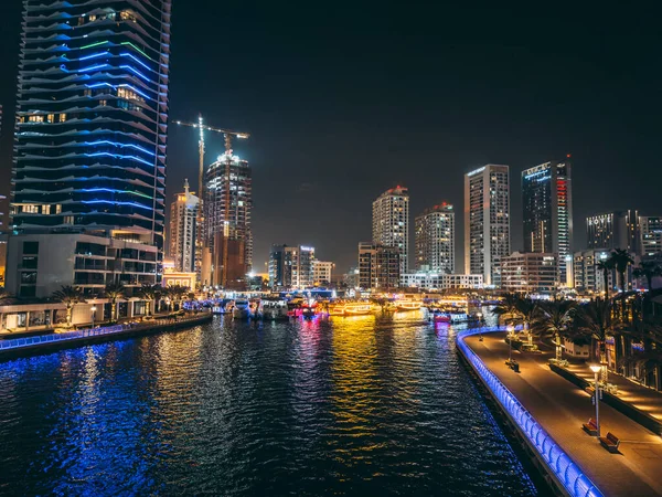 stock image Dubai Marina, harbour, cruise boat and canal promenade view at night, in Dubai, United Arab Emirates. High quality photo