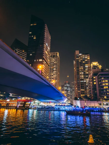 stock image Dubai Marina, harbour, cruise boat and canal promenade view at night, in Dubai, United Arab Emirates. High quality photo