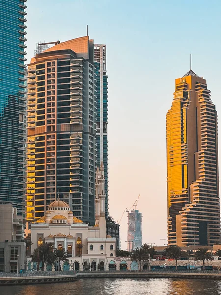 Stock image Dubai Marina Mosque, harbour, cruise boat and canal promenade view at sunset, in Dubai, United Arab Emirates. High quality photo