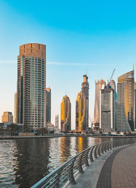 stock image Dubai Marina Mosque, harbour, cruise boat and canal promenade view at sunset, in Dubai, United Arab Emirates. High quality photo