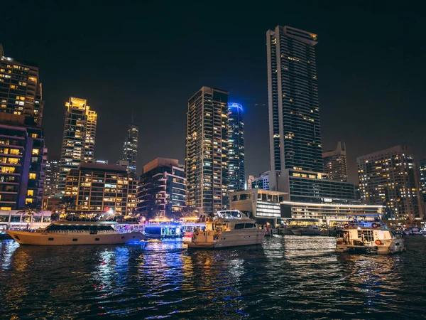 stock image Dubai Marina, harbour, cruise boat and canal promenade view at night, in Dubai, United Arab Emirates. High quality photo