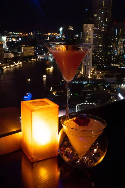 Cocktail in a jazz lounge bar with the view on Chao Phraya river in Bangkok, Thailand, south east asia