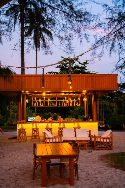 stock image Sunset at the beach bar in Mai Khao Beach Resort in Phuket Thailand. High quality photo