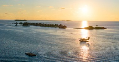 Aerial views of Velavaru Island at sunset in Maldives, Asia clipart