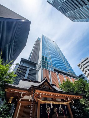 Fukutoku Shrine with view of skyscrapers in business center, Tokyo, Japan. High quality photo clipart