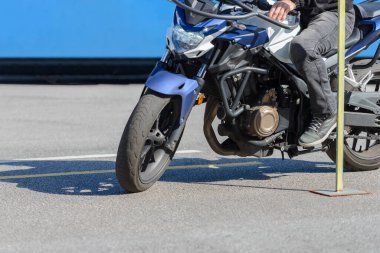 training in a motorcycle school, a detour of a vertical rack, close-up clipart