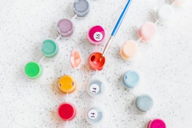 Acrylic paints for painting pictures by numbers top view. Hobby and leisure activity. Home drawing and learning