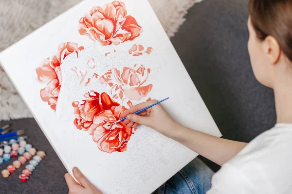 home entertainment idea. painting by numbers. Young woman drawing picture with acrylic paints on canvas, enjoying creative leisure activities. Hobbies for girls