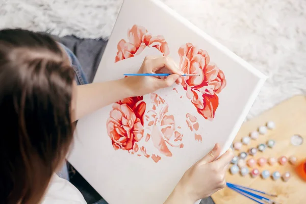 home entertainment idea. painting by numbers. Young woman drawing picture with acrylic paints on canvas, enjoying creative leisure activities. Hobbies for girls