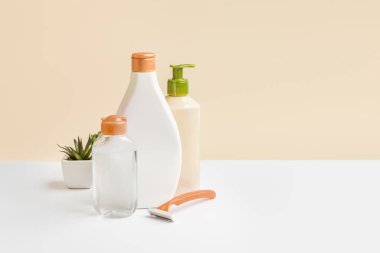 Body and face care. Micellar water jar, body lotion, depilatory razor copy space