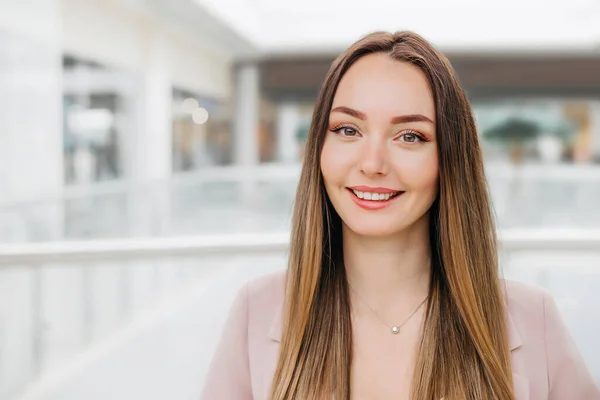 Stock image Close up portrait of a young caucasian brunette woman in a beige business suit. copy space