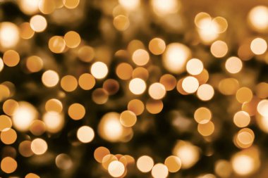 Arka planda siyah arka planda altın turuncu bokeh. Noel arkaplanı