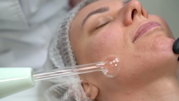 Relaxed Girl Beautician Clinic Facial Stimulation Procedure Darsonval Device Professional — Stock Video
