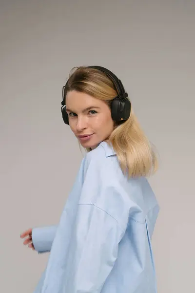 Listening Music Young Caucasian Blonde Woman Looks Camera Half Turn Stockfoto