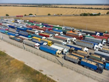 A long line of trucks in the port terminal. Trucks are waiting to unload grain