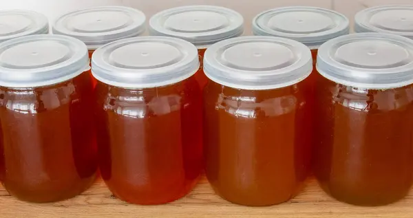 Close-up of fresh buckwheat honey in jars on the table