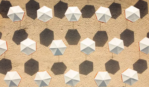 White umbrellas on the wall. Seamless pattern
