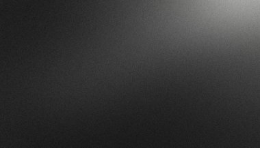 Kum tanecikli siyah arkaplan ve üstten solan bir ışık lekesi