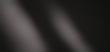 Kumlu siyah arkaplan dokusu parlak bir ışık demeti tarafından aydınlatılıyor