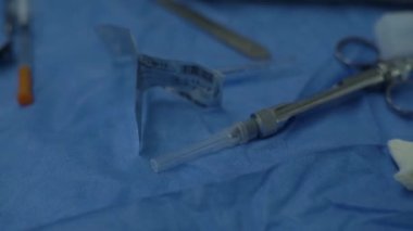 Surgical dental instruments table during operation remove wisdom teeth patient under general anesthesia. Tooth extraction. Scalpel blood. Carpool syringe for anesthesia. Bone grafting, installation