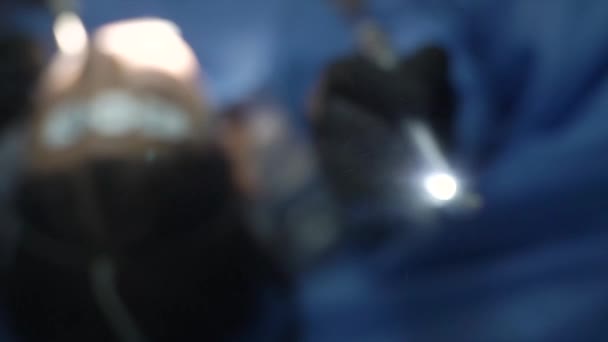 一名戴着黑色面具的男牙医在工作时面部的特写 牙科医生戴着硝酸盐手套摘除了一颗复杂的智齿 男性牙医的概念 相机缩放 — 图库视频影像