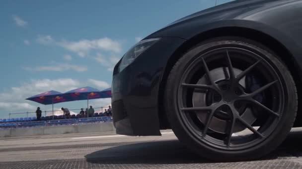 ザポロジー ウクライナ 2020年7月12日 レースでスポーツカーの鋭いスタート バンパー タイヤ タイヤのクローズアップ スタンド ファンを背景に — ストック動画