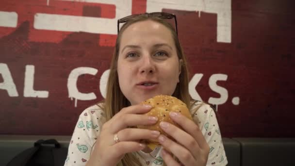 Jonge Hongerige Vrouw Die Gretig Een Vleesburger Eet Een Fastfood — Stockvideo