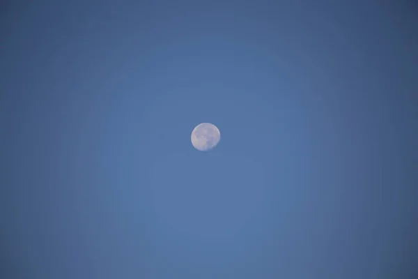 Full moon in the daytime sky