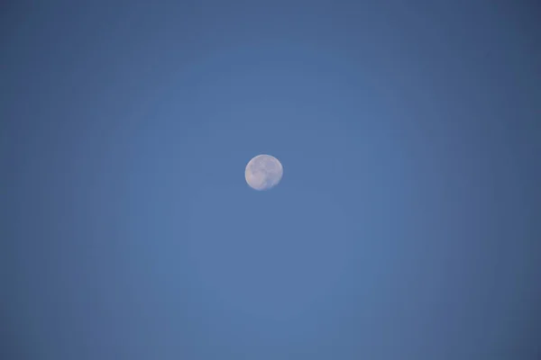 Full moon in the daytime sky